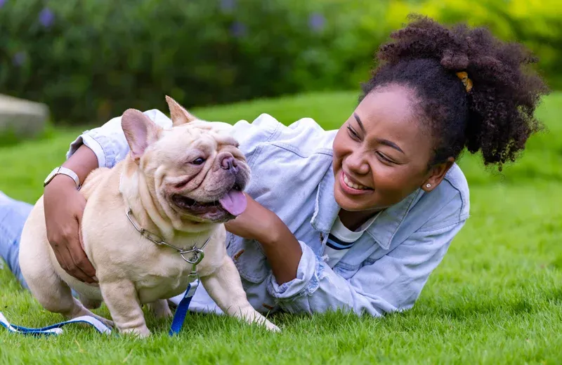 woman playing with her pet dog outside