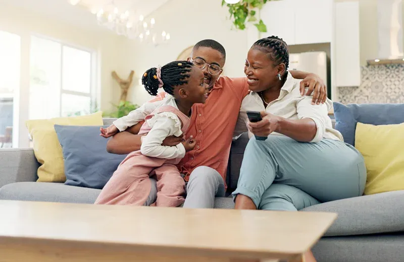 happy family laughing and watching tv in pest free home