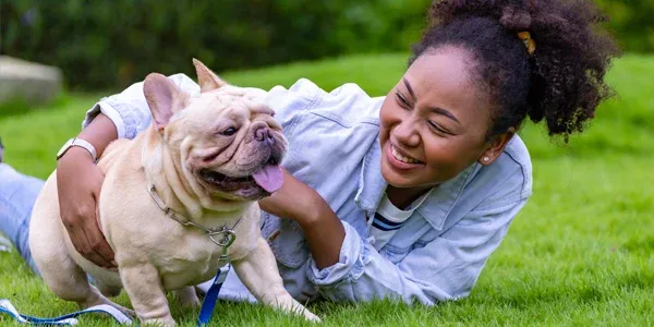 woman playing with dog outside