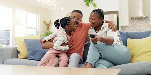 happy family laughing and watching tv in pest free home